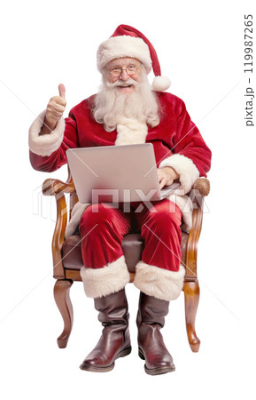 Santa Claus sits in a chair with a laptop, giving a thumbs up 119987265