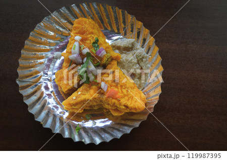 Bread pakoda or bhaji which is deep fried bread slices covered in spicy gram flour batter garnished with onions and coriander with chutney, authentic local nepali street food Bread pakoda or bhaji which is deep fried bread slices covered in spicy gram flour batter garnished with onions and coriander with chutney, authentic local nepali street food 119987395
