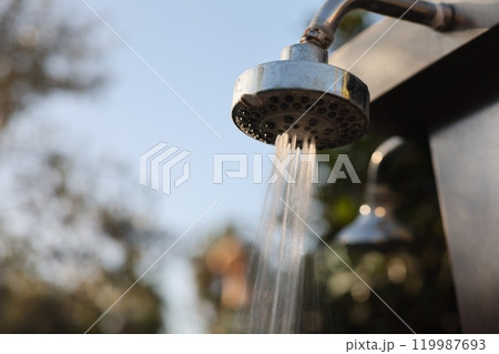 Experience the bliss of an Outdoor Shower Head with Flowing Water in Beautiful Nature Experience the bliss of an Outdoor Shower Head with Flowing Water in Beautiful Nature 119987693