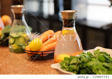 Experience the Delight of Fresh Ingredients and Refreshing Beverages on a Kitchen Counter Experience the Delight of Fresh Ingredients and Refreshing Beverages on a Kitchen Counter 119987741