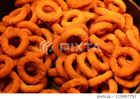 Enjoy some delightful Crunchy Orange Snack Rings served fresh and inviting in a bowl 119987792