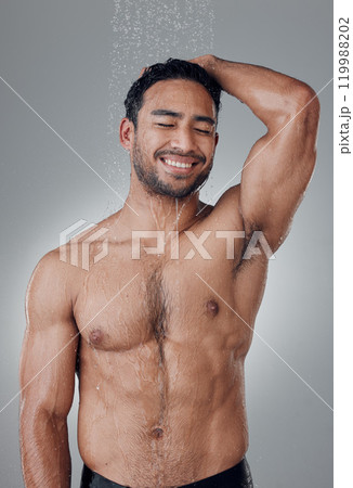 Man, shower and cleaning in studio for haircare, water and confident for grooming on gray background. Male person, cosmetics and liquid for treatment in morning routine, health and hygiene or beauty Man, shower and cleaning in studio for haircare, water and confident for grooming on gray background. Male person, cosmetics and liquid for treatment in morning routine, health and hygiene or beauty 119988202