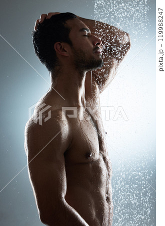 Man, shower and washing in studio for hygiene, cosmetics and cleaning on gray background. Male person, profile and water drops for pamper treatment or dermatology, grooming and hydration beauty Man, shower and washing in studio for hygiene, cosmetics and cleaning on gray background. Male person, profile and water drops for pamper treatment or dermatology, grooming and hydration beauty 119988247