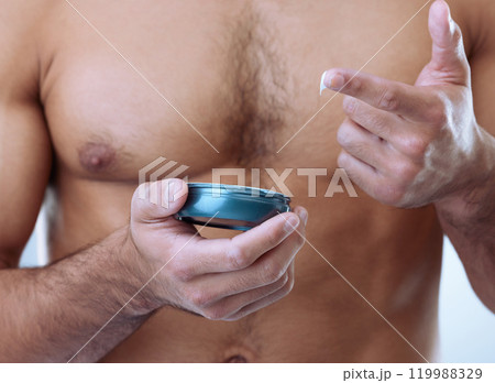 Hands, skincare and man with luxury cream on studio background for moisturizer, cosmetics or morning routine. Closeup, grooming and chest of model with product for lotion, sunscreen or body care Hands, skincare and man with luxury cream on studio background for moisturizer, cosmetics or morning routine. Closeup, grooming and chest of model with product for lotion, sunscreen or body care 119988329