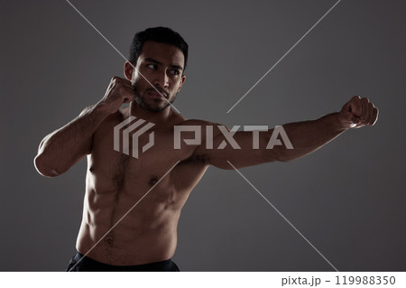 Man, boxer and punching in studio for fitness for mma sport, fighter and background or training for challenge or competition fight. Strong, power and exercise for strength, combat workout and health Man, boxer and punching in studio for fitness for mma sport, fighter and background or training for challenge or competition fight. Strong, power and exercise for strength, combat workout and health 119988350