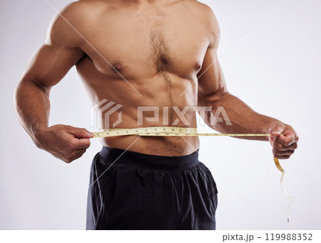 Fitness, man and measuring tape in studio white background for progress check, weight loss or body care. Male person, diet or fat tracking for wellness, health nutrition or exercise and workout 119988352