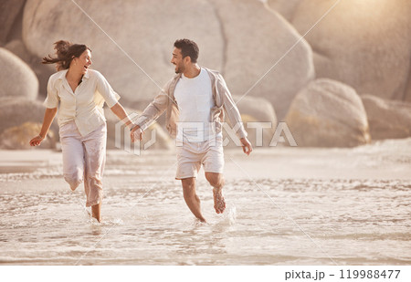 Running, happy couple and holding hands at ocean on vacation, summer holiday or travel outdoor together. Laugh, man and woman at beach for love, support and connection for romantic date at sea water Running, happy couple and holding hands at ocean on vacation, summer holiday or travel outdoor together. Laugh, man and woman at beach for love, support and connection for romantic date at sea water 119988477
