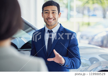 People, car dealership and salesman with client, pride and confidence for transport, loan or test drive in automobile. Woman, man and excited in showroom for decision in buying new vehicle in shop People, car dealership and salesman with client, pride and confidence for transport, loan or test drive in automobile. Woman, man and excited in showroom for decision in buying new vehicle in shop 119988529