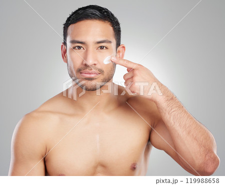 Portrait, beauty and man with cream, skincare and dermatology on white studio background. Face, person and model with cosmetics, facial or creme for healthy skin, lotion and wellness with grooming 119988658
