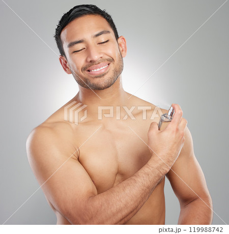 Man, cologne and spray with happiness in studio for hygiene, scent and morning routine for grooming. Smile, skincare and confidence with getting ready, self care and luxury body perfume in bottle. 119988742