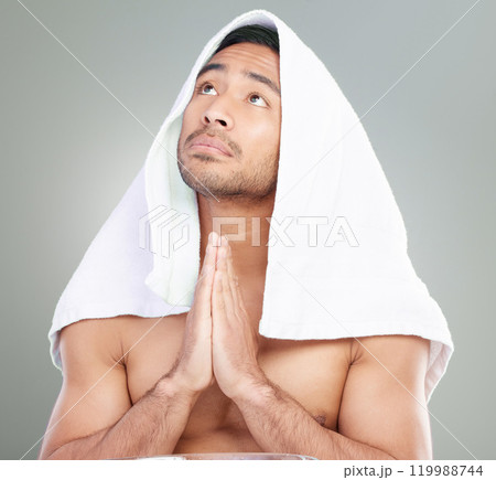 Thinking, prayer hands and shirtless man in studio with towel spiritual, hope or catholic faith with respect on white background. Body, religion and model for skincare, morning routine or grooming 119988744