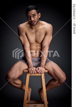 Confident, portrait and man body in studio fitness, wellness and muscular care for inspiration on chair. Person, aesthetic and exercise with strength workout for health on stool by black background 119988782