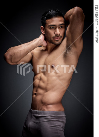 Fitness, asian man and body builder flexing abs and strong chest in sexy underwear for exercise in studio. Health, sport and male person with seductive stomach muscles for training on dark background 119988783