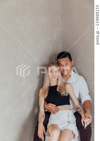 Man And Woman Sitting Together Side By Side Hugging And Smiling Man And Woman Sitting Together Side By Side Hugging And Smiling 119989155