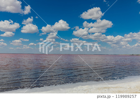 Beautiful landscape, salty pink lake and blue sky with clouds Beautiful landscape, salty pink lake and blue sky with clouds 119989257