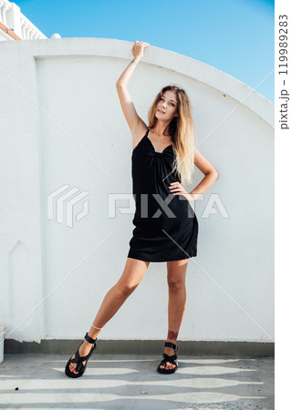 Beautiful woman in light summer black scarf smiling 119989283