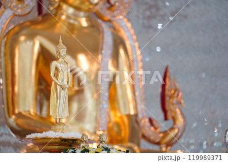A stunning golden Buddha sculpture, exemplifying the deep reverence and devotion of Thai individuals in their spiritual worship. A stunning golden Buddha sculpture, exemplifying the deep reverence and devotion of Thai individuals in their spiritual worship. 119989371