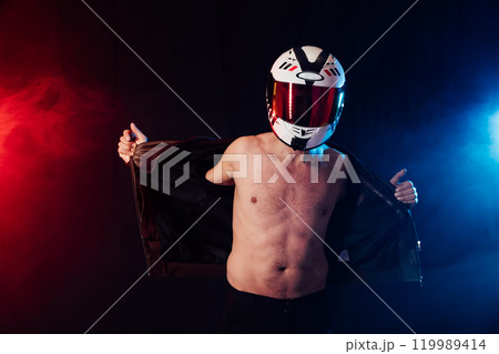 Man in a motorcycle helmet on a bare torso Man in a motorcycle helmet on a bare torso 119989414