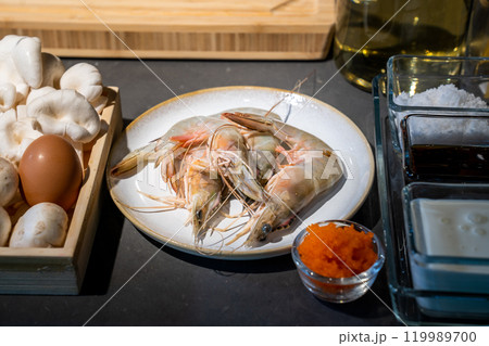 Focused on Shrimp in among of ingredients, mushroom, egg, sauce, tobiko, for meal cooking. Focused on Shrimp in among of ingredients, mushroom, egg, sauce, tobiko, for meal cooking. 119989700