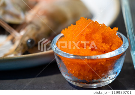 Focused on fresh Tobiko, flying fish roe with blur Shrimp beside it. 119989701