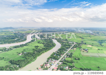 Top view of the Sakae Krang River, Uthai Thani Province where both sides of river are filled with lush green trees. There are community near waterside. 119989948