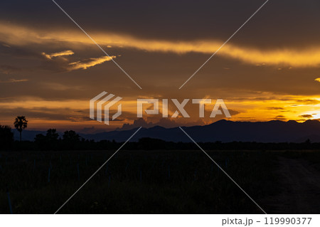 Senset moment view behind the mountain in the golden light from the sun. 119990377