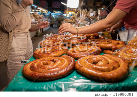 Sai Aua, Northern Thailand Spicy Sausage is a famous Traditional Local saurage cooked with curry and herb, lay on shop and ready for sales. Sai Aua, Northern Thailand Spicy Sausage is a famous Traditional Local saurage cooked with curry and herb, lay on shop and ready for sales. 119990391