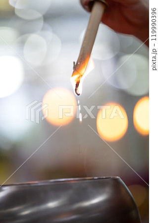 A drops of melting wax upside down with blur circle bokeh in religious event A drops of melting wax upside down with blur circle bokeh in religious event 119990396