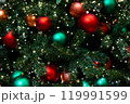 Background of red, green, orange balls toys and lights on green indoor Christmas tree on New Year 119991599