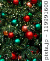 Vertical background of red, green, orange balls toys and lights green indoor Christmas tree New Year 119991600