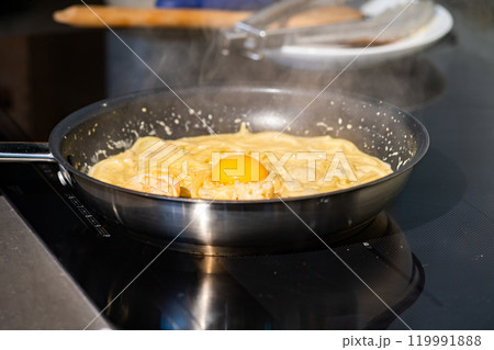 Close up macro to yolk in Creamy fried and boiled Spaghetti pasta in hot pan. Close up macro to yolk in Creamy fried and boiled Spaghetti pasta in hot pan. 119991888