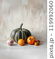 Natural still life with orange and green pumpkins, tomatoes and onions. Bright background with copy space. Thanksgiving, production for the market, harvest concept 119992060