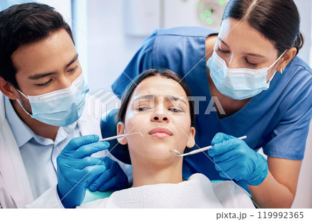 Patient, worry and dentist with equipment in clinic with oral health, healthcare and dental care for teeth. Girl, scalers and orthodontist tools in hospital for cleaning and scared with mask Patient, worry and dentist with equipment in clinic with oral health, healthcare and dental care for teeth. Girl, scalers and orthodontist tools in hospital for cleaning and scared with mask 119992365