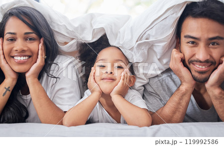 Child, parents and portrait for family in bed with love relationship, support and bonding together in home. Mother, father and young girl in bedroom for morning wake up with lazy weekend and relax Child, parents and portrait for family in bed with love relationship, support and bonding together in home. Mother, father and young girl in bedroom for morning wake up with lazy weekend and relax 119992586