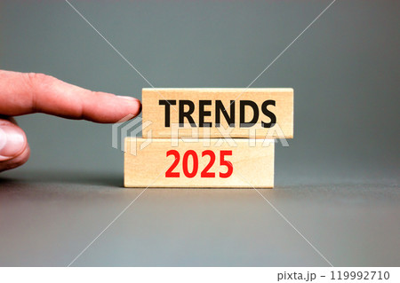 Planning trends 2025 new year symbol. Concept words Trends 2025 on beautiful wooden blocks. Beautiful grey background. Businessman hand. Business trends 2025 new year concept. Copy space. 119992710