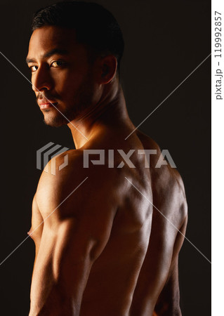 Back, fitness and portrait of man with muscles in studio for workout, sports and wellness or training. Bodybuilder, athlete and male person for progress and results by black background with pride Back, fitness and portrait of man with muscles in studio for workout, sports and wellness or training. Bodybuilder, athlete and male person for progress and results by black background with pride 119992857