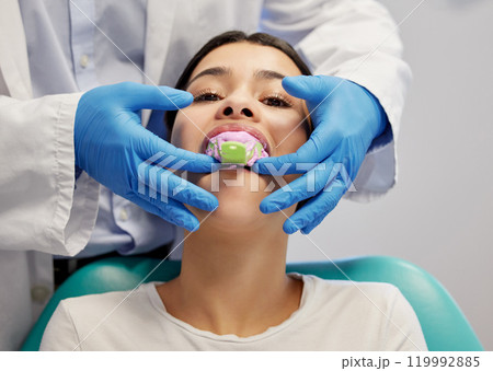 Dentist, dental and rubber dam for toothache in clinic, treatment and health for cleaning mouth. Teeth whitening, patient and person with torque wrench machine, orthodontics and oral care for veneers 119992885