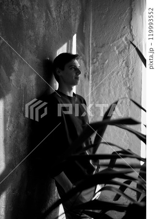 portrait of an attractive young 20 year old man with dark hair and blue eyes, studio photo shoot portrait of an attractive young 20 year old man with dark hair and blue eyes, studio photo shoot 119993552