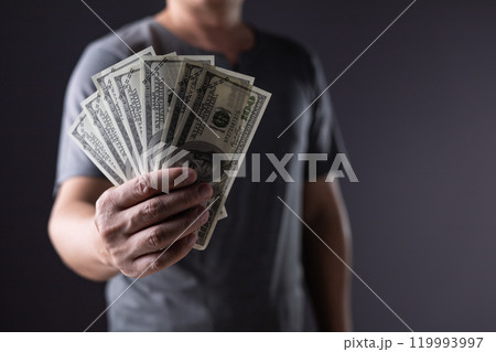 business man holding 100 cash bills Dollar currency, investment finance concept, success in business. 119993997