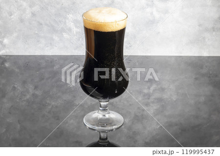 Glasses with light and dark beer on a dark background. Nuts and crackers Glasses with light and dark beer on a dark background. Nuts and crackers 119995437