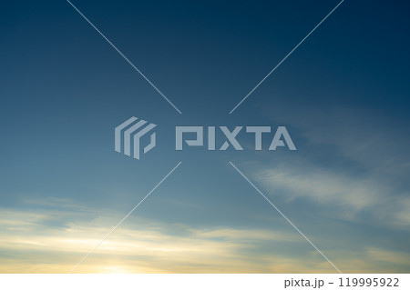 Blue Sky with Light Pink Cirrus Clouds at Sunset Abstract Texture Background Blue Sky with Light Pink Cirrus Clouds at Sunset Abstract Texture Background 119995922