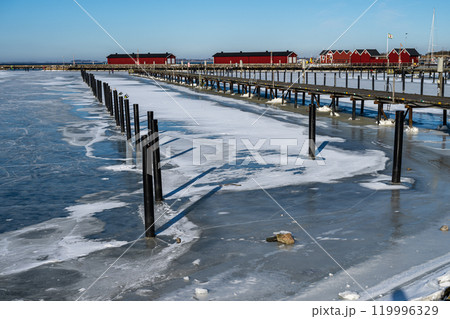 Ice covering a yacht marina. Blue sky background. Picture from Lomma, Sweden Ice covering a yacht marina. Blue sky background. Picture from Lomma, Sweden 119996329