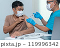 Doctor Administering Vaccine Injection to Patient's Arm in Medical Setting 119996342