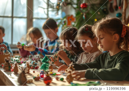 Children gathered around a table making handmade Christmas ornaments with colorful craft supplies Children gathered around a table making handmade Christmas ornaments with colorful craft supplies 119996396