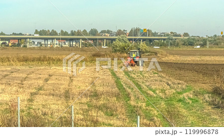 Agricultural fields with young green shoots of grain crops and plowed field without sowing. With trees in the background on the hills. Fallow concept. Alternation. High quality photo Agricultural fields with young green shoots of grain crops and plowed field without sowing. With trees in the background on the hills. Fallow concept. Alternation. High quality photo 119996878