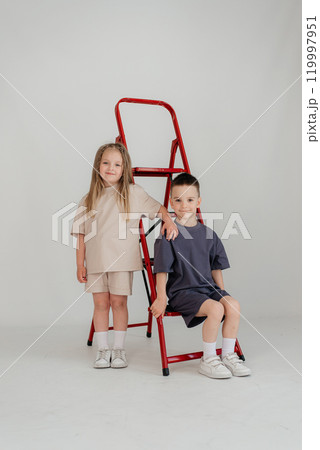 Little couple kids boy girl 4-5 years old clothes shirt dress posing have fun isolated on white background children studio portrait. People childhood lifestyle Little couple kids boy girl 4-5 years old clothes shirt dress posing have fun isolated on white background children studio portrait. People childhood lifestyle 119997951