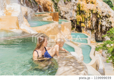 Mother with her toddler son bathing in the hot springs of Grutas Tolantongo, Mexico. Family adventure, relaxation, and natural wellness concept 119999039