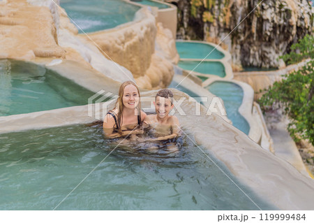 Mother with her toddler and teenage sons bathing in the hot springs of Grutas Tolantongo, Mexico. Family adventure, relaxation, and natural wellness concept Mother with her toddler and teenage sons bathing in the hot springs of Grutas Tolantongo, Mexico. Family adventure, relaxation, and natural wellness concept 119999484