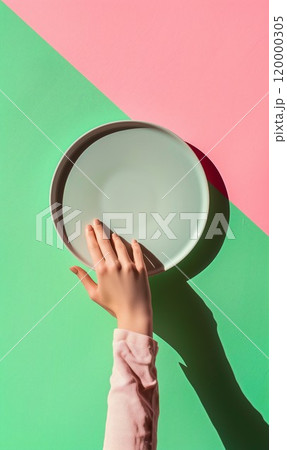 woman hand holding empty plate, in style of pink and green 120000305