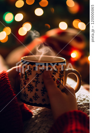 Warm drink by the Christmas tree 120000865